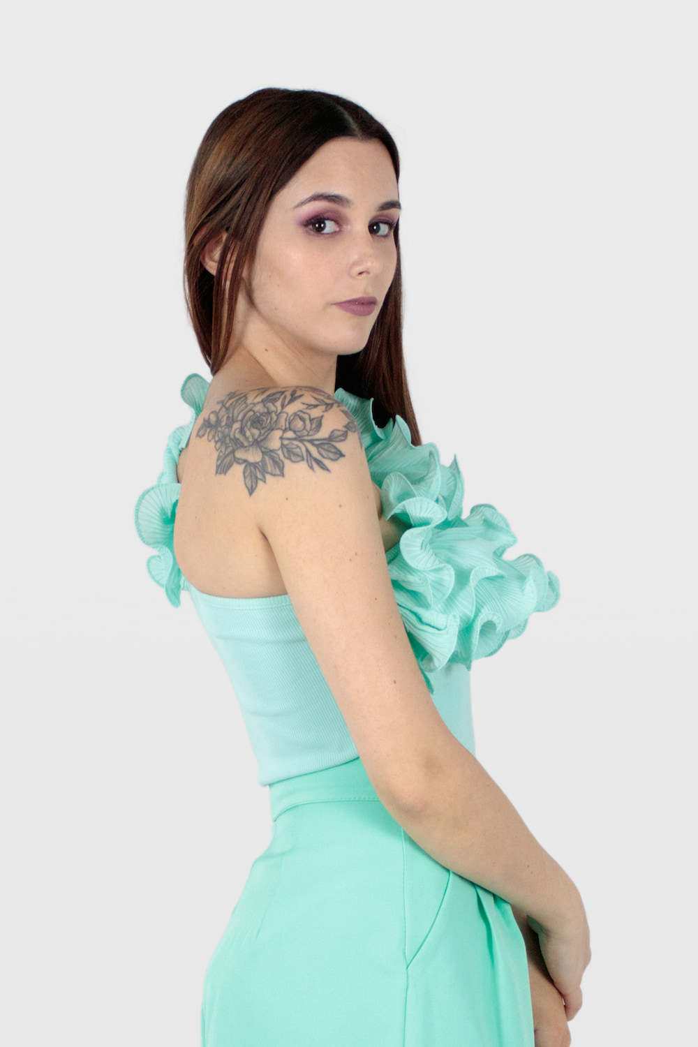 Body assimétrico com folhos no decote verde, lado direito.